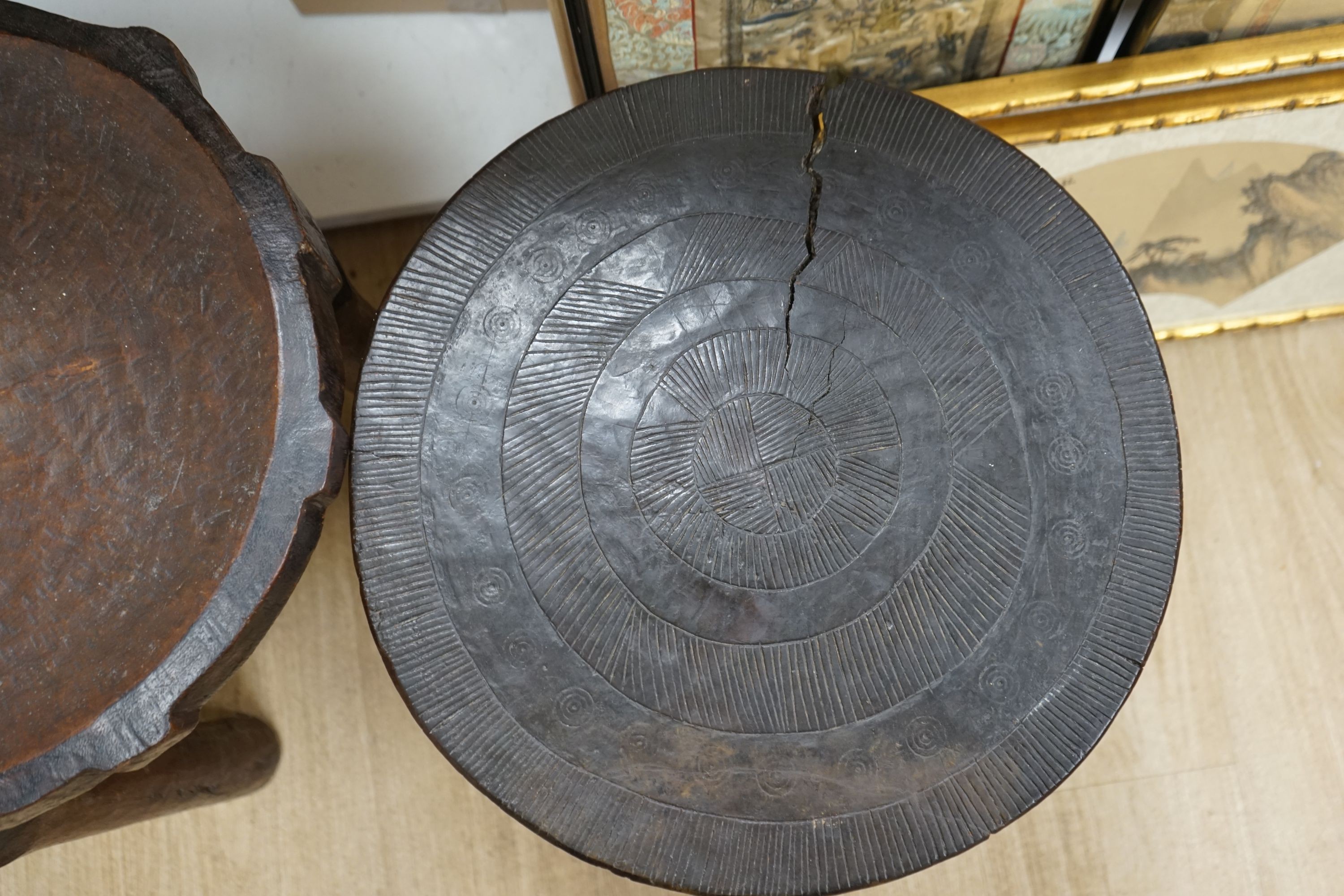 Two African circular carved hardwood low tables, larger 46cm diameter, height 50cm